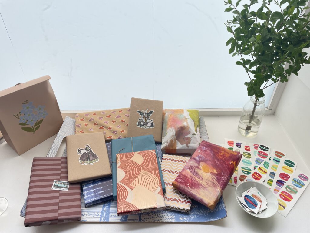 gift-wrapped books with hand-painted watercolor macarons bookmarks by Cynthia Morris